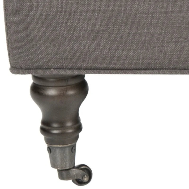 Pouf cocktail con bottoni trapuntati e gambe in legno